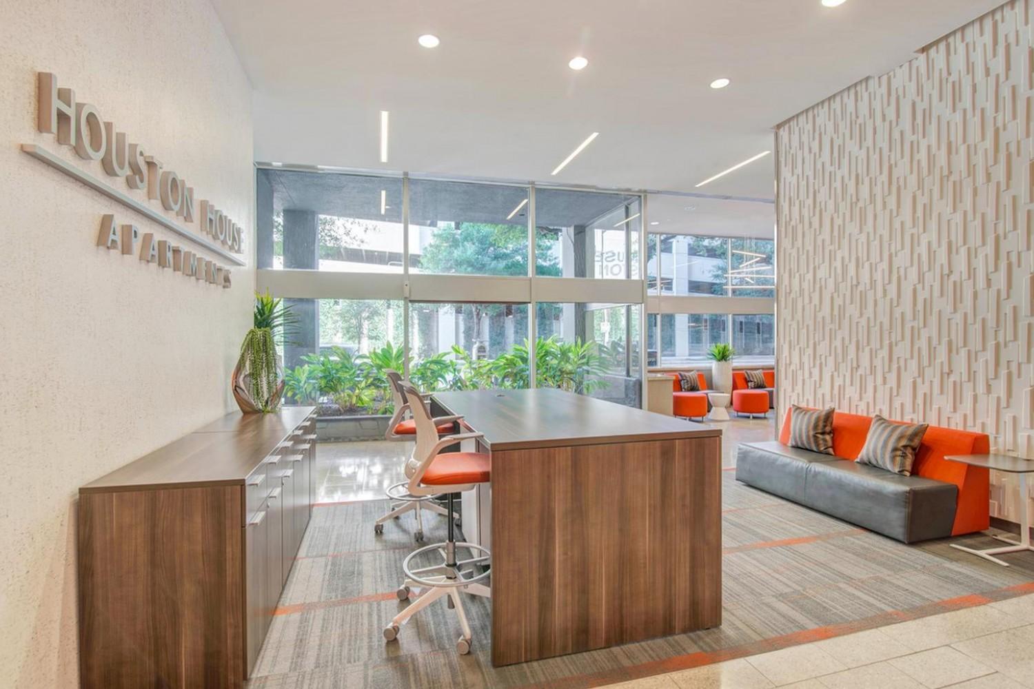 Leasing office lobby with reception desk and sofas