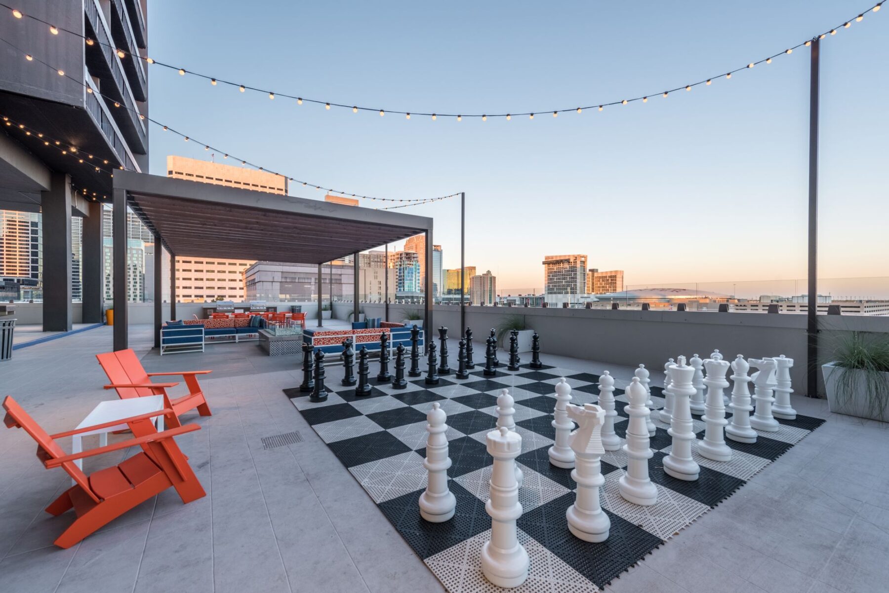 Rooftop patio with covered sitting area and giant chess game